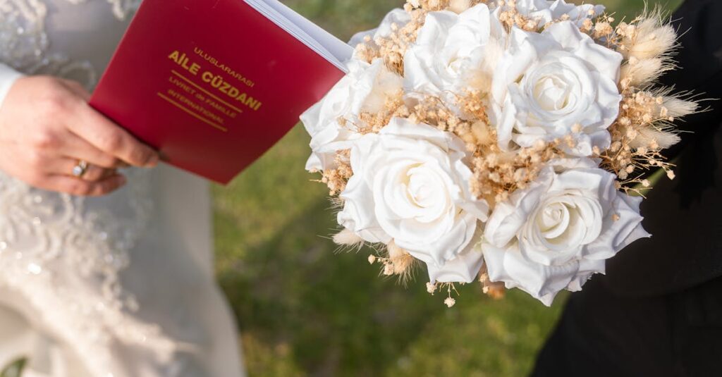 Close-up of a wedding bouquet and marriage certificate held by a couple outdoors, capturing a special moment.